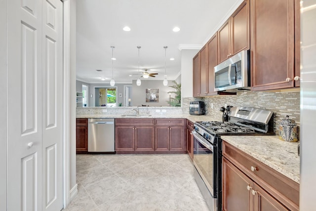 kitchen with tasteful backsplash, stainless steel appliances, ceiling fan, and a sink