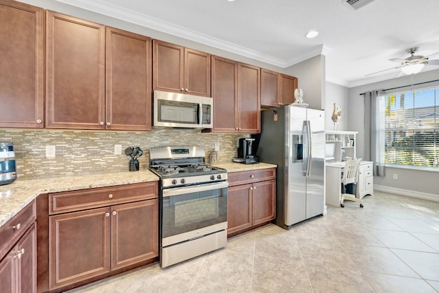 kitchen with light stone counters, a ceiling fan, ornamental molding, appliances with stainless steel finishes, and backsplash