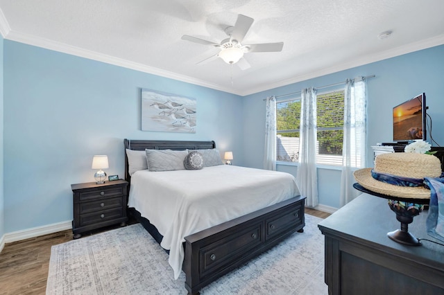 bedroom featuring light wood-style floors, crown molding, and a textured ceiling