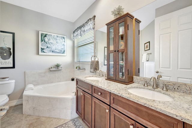 bathroom with a sink, toilet, a bath, and double vanity