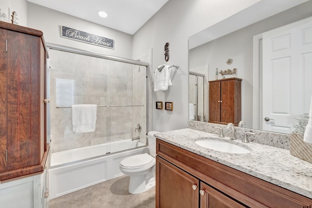 bathroom with tile patterned flooring, toilet, vanity, and bath / shower combo with glass door