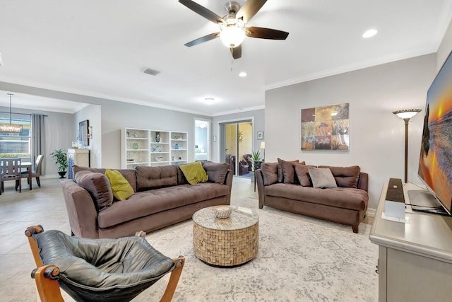 living room featuring light tile patterned floors, baseboards, recessed lighting, ornamental molding, and ceiling fan with notable chandelier