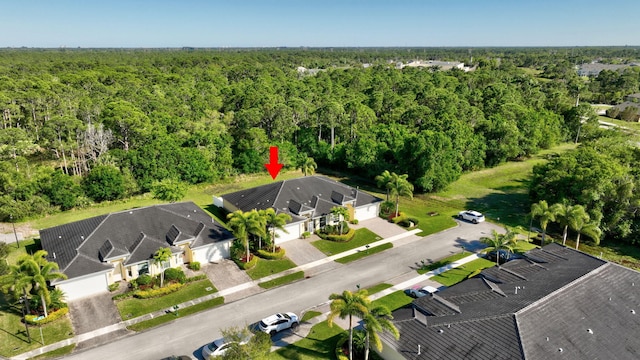 birds eye view of property with a view of trees