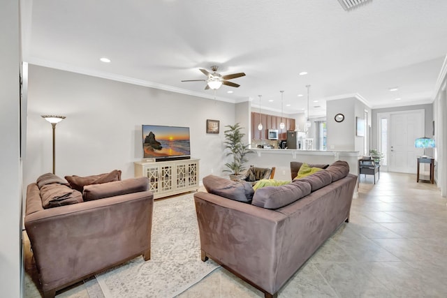 living area with light tile patterned floors, a ceiling fan, recessed lighting, and crown molding