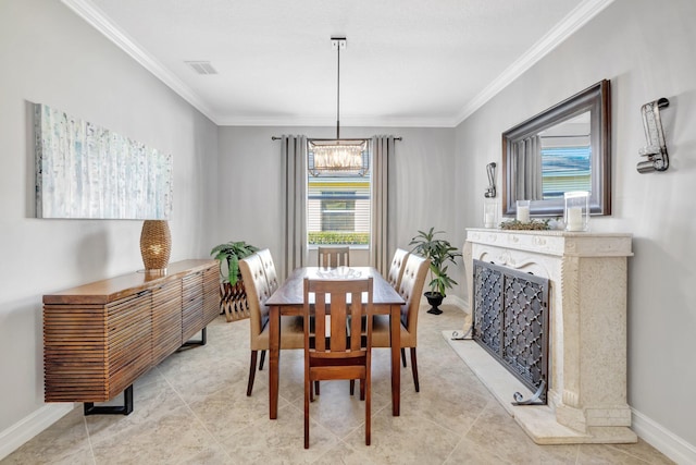 dining room with crown molding, baseboards, and a chandelier