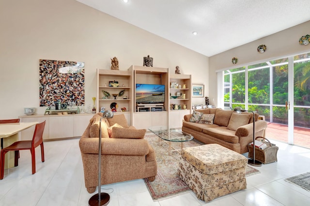 living area with light tile patterned floors and high vaulted ceiling