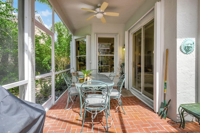 sunroom with a ceiling fan