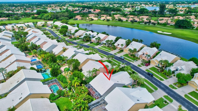 aerial view with a residential view, view of golf course, and a water view