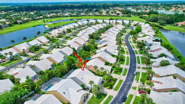 bird's eye view featuring a water view, view of golf course, and a residential view