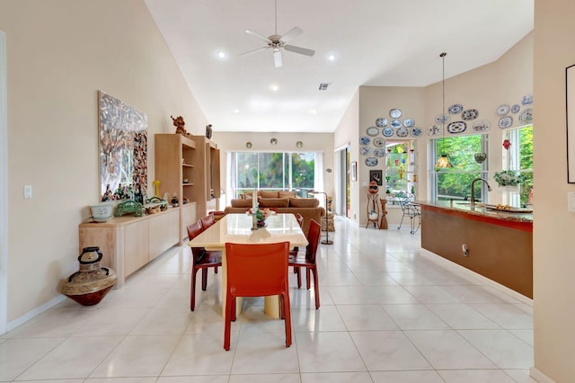 dining room with ceiling fan, high vaulted ceiling, light tile patterned flooring, and visible vents