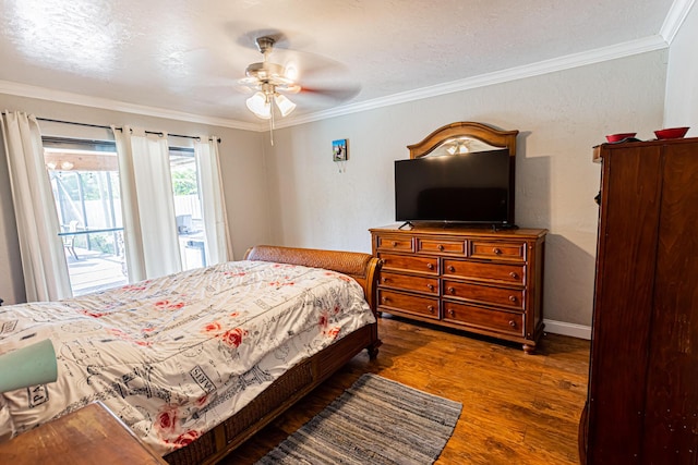 bedroom featuring baseboards, wood finished floors, crown molding, and access to outside