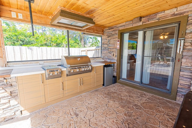 view of patio / terrace featuring area for grilling, an outdoor kitchen, and fence