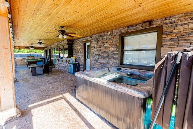 view of patio featuring a ceiling fan and a hot tub