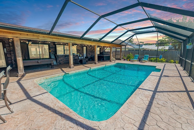 view of pool featuring a ceiling fan, a patio, a fenced backyard, glass enclosure, and a fenced in pool