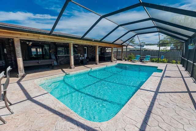 view of swimming pool featuring a lanai, a fenced in pool, a patio, and a fenced backyard