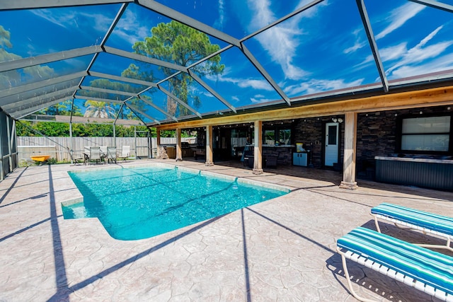 view of pool with a patio, a fenced backyard, and a lanai