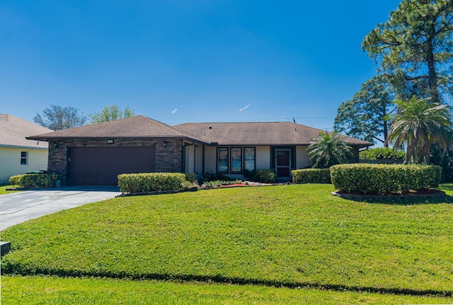 view of front of property featuring stone siding, an attached garage, concrete driveway, and a front lawn