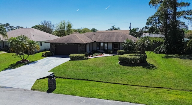 view of front of home with a front yard, an attached garage, and driveway