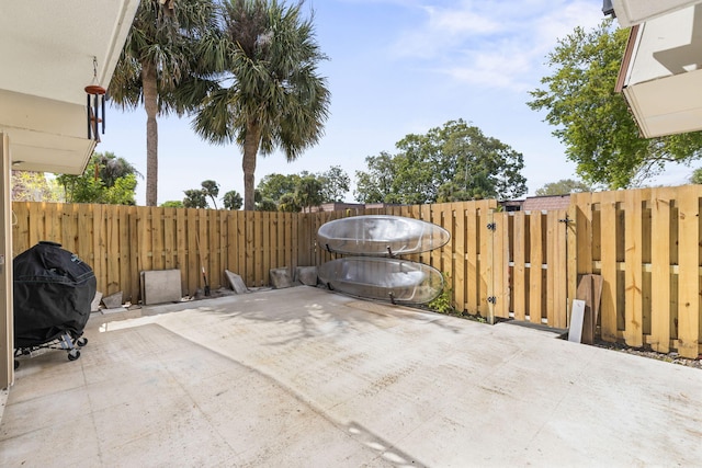 view of patio with fence and area for grilling