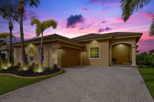 4113 Worlington Ter, Fort Pierce, FL 34947 - view of front of house with an attached garage, stucco siding, decorative driveway, and a tile roof
