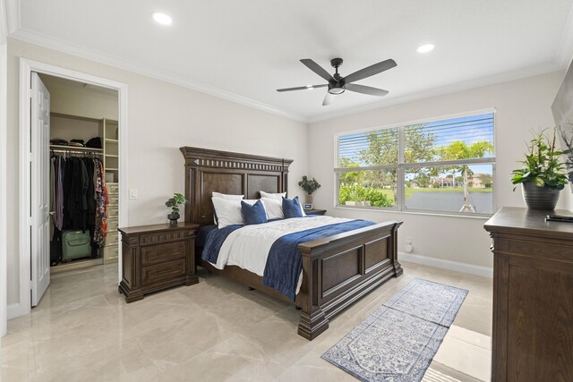 bedroom with a ceiling fan, baseboards, recessed lighting, a walk in closet, and crown molding