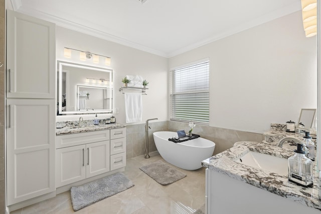 bathroom featuring a soaking tub, two vanities, crown molding, and a sink