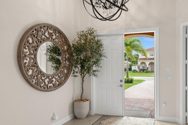 tiled foyer featuring baseboards