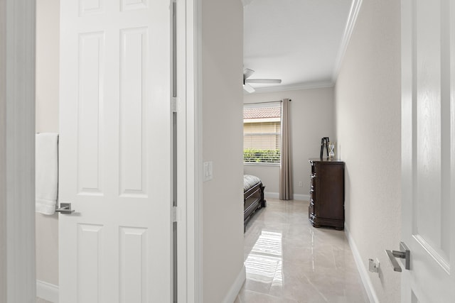 hall featuring baseboards, marble finish floor, and ornamental molding