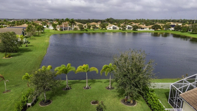 drone / aerial view featuring a water view and a residential view