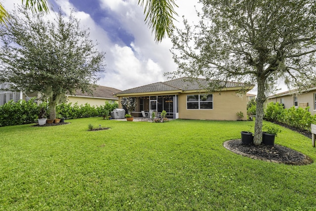 4113 Worlington Ter, Fort Pierce, FL 34947 - rear view of property featuring a sunroom, stucco siding, a lawn, and a tile roof