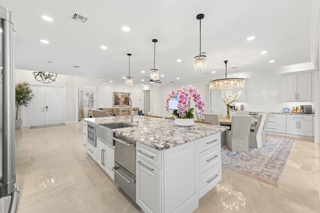 kitchen with visible vents, an island with sink, recessed lighting, a warming drawer, and a sink