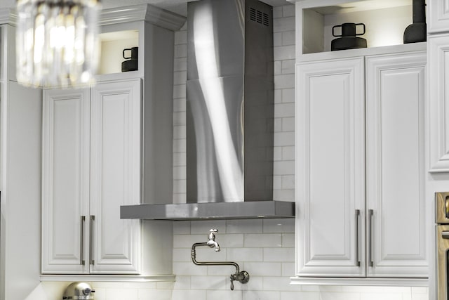 room details with wall chimney range hood