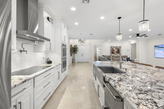 4113 Worlington Ter, Fort Pierce, FL 34947 - kitchen with wall chimney exhaust hood, a chandelier, appliances with stainless steel finishes, white cabinetry, and decorative backsplash