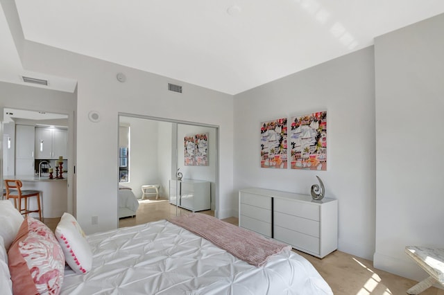 bedroom featuring a closet, visible vents, and a sink