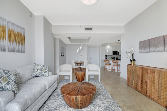 living room featuring visible vents and attic access