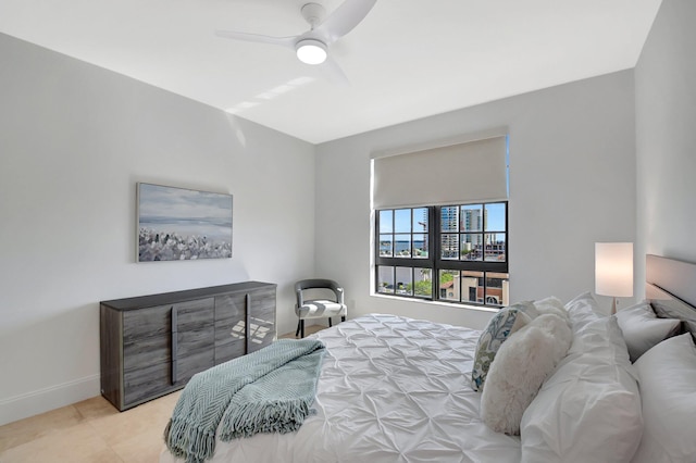 bedroom featuring a ceiling fan and baseboards