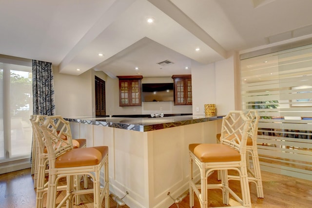 bar featuring indoor wet bar, recessed lighting, visible vents, and light wood finished floors