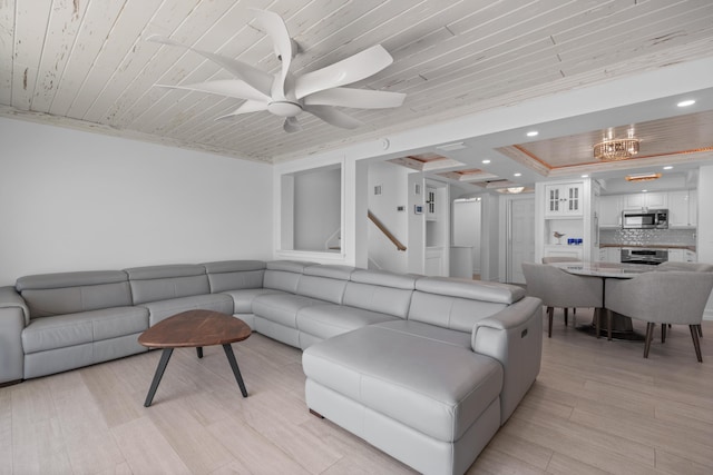 living room featuring recessed lighting, wooden ceiling, light wood-style flooring, and a tray ceiling