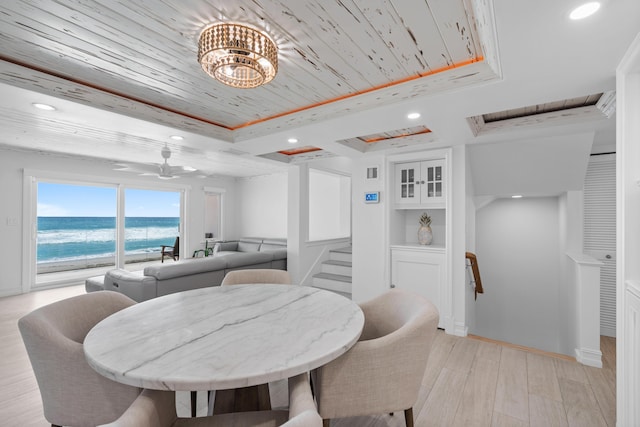 dining space with wood ceiling, a tray ceiling, light wood-style flooring, and recessed lighting