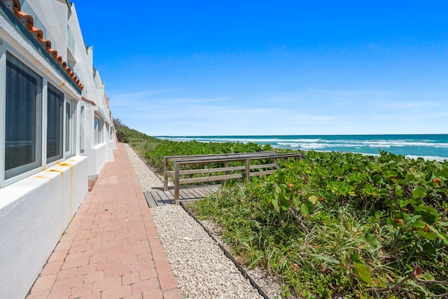 exterior space with a water view and a view of the beach