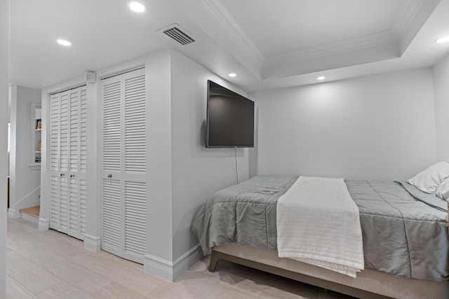 bedroom with recessed lighting, visible vents, baseboards, a tray ceiling, and crown molding