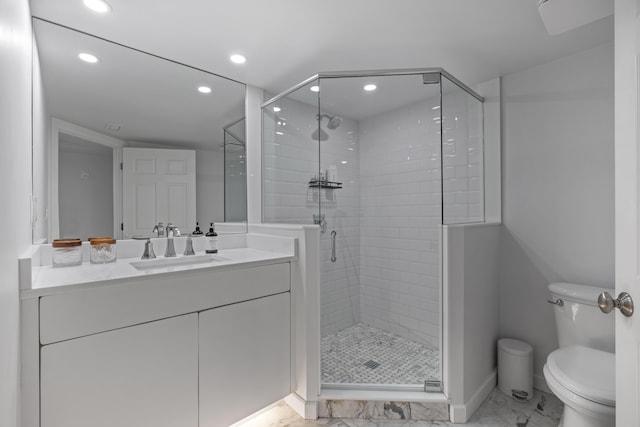 bathroom featuring a stall shower, toilet, marble finish floor, vanity, and recessed lighting