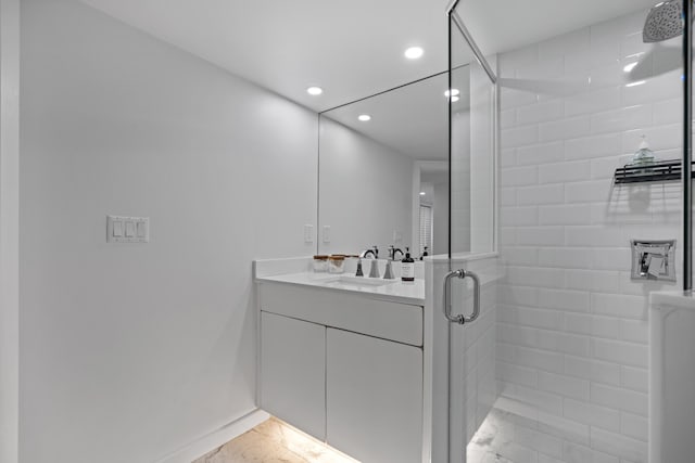 bathroom with recessed lighting, a shower stall, and vanity