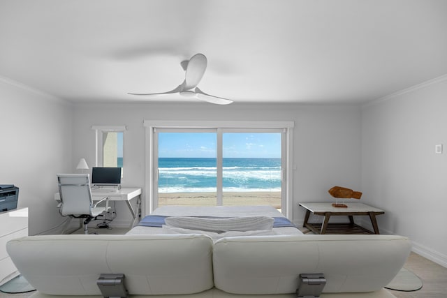 interior space featuring ceiling fan, baseboards, and crown molding