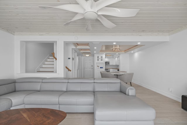 living room featuring light wood finished floors, baseboards, a ceiling fan, stairs, and recessed lighting