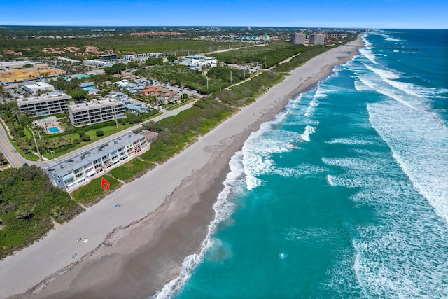 drone / aerial view with a water view and a view of the beach