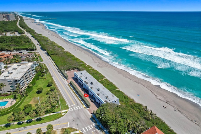 drone / aerial view featuring a view of the beach and a water view