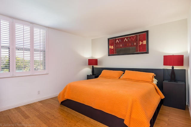 bedroom featuring baseboards and wood finished floors