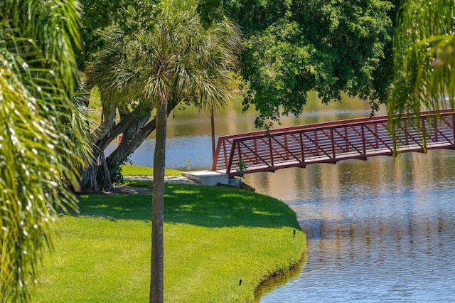 view of dock featuring a yard and a water view