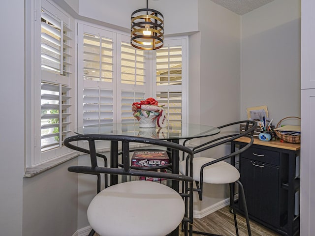 dining area featuring baseboards and wood finished floors